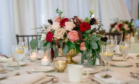 Flower Arrangement in Warm Shades
Photography: David Manning Photographer
Read More:
http://www.insideweddings.com/weddings/interfaith-ceremony-tented-reception-with-romantic-color-palette/885/ red blush ivory roses with eucalyptus and greenery, gold bowl