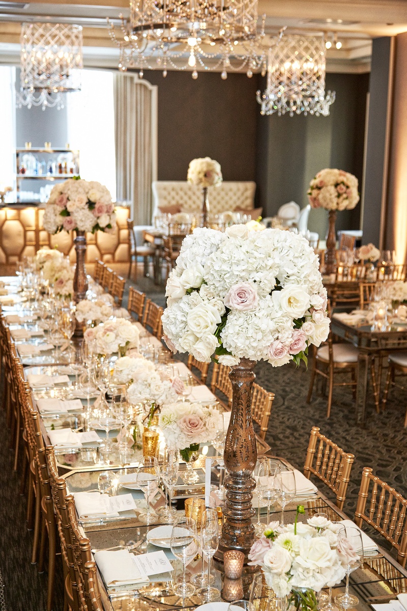 Elegant Long Reception Tablescape
Photography: KingenSmith
Read More:
http://www.insideweddings.com/weddings/catholic-ceremony-soft-romantic-fairy-tale-reception-in-chicago/754/ gold chiavari chairs, rose centerpieces on long family tables with mirror tops under chandelier