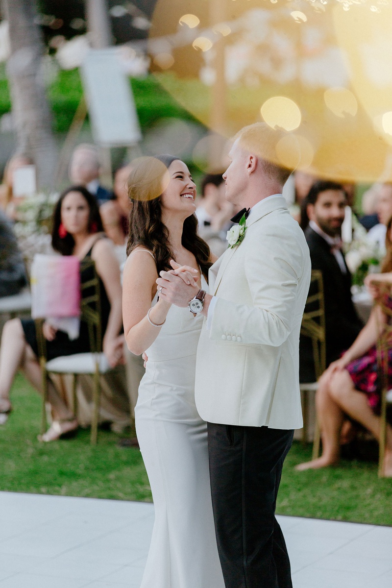 First Dance at Outdoor Hawaii Wedding
Photography: Chris J. Evans Photography
Read More:
http://www.insideweddings.com/weddings/outdoor-winter-ceremony-and-reception-on-the-big-island-in-hawaii/1306/ wedding reception white dance floor outdoor hawaii venue gold chairs white tuxedo jacket crepe dress