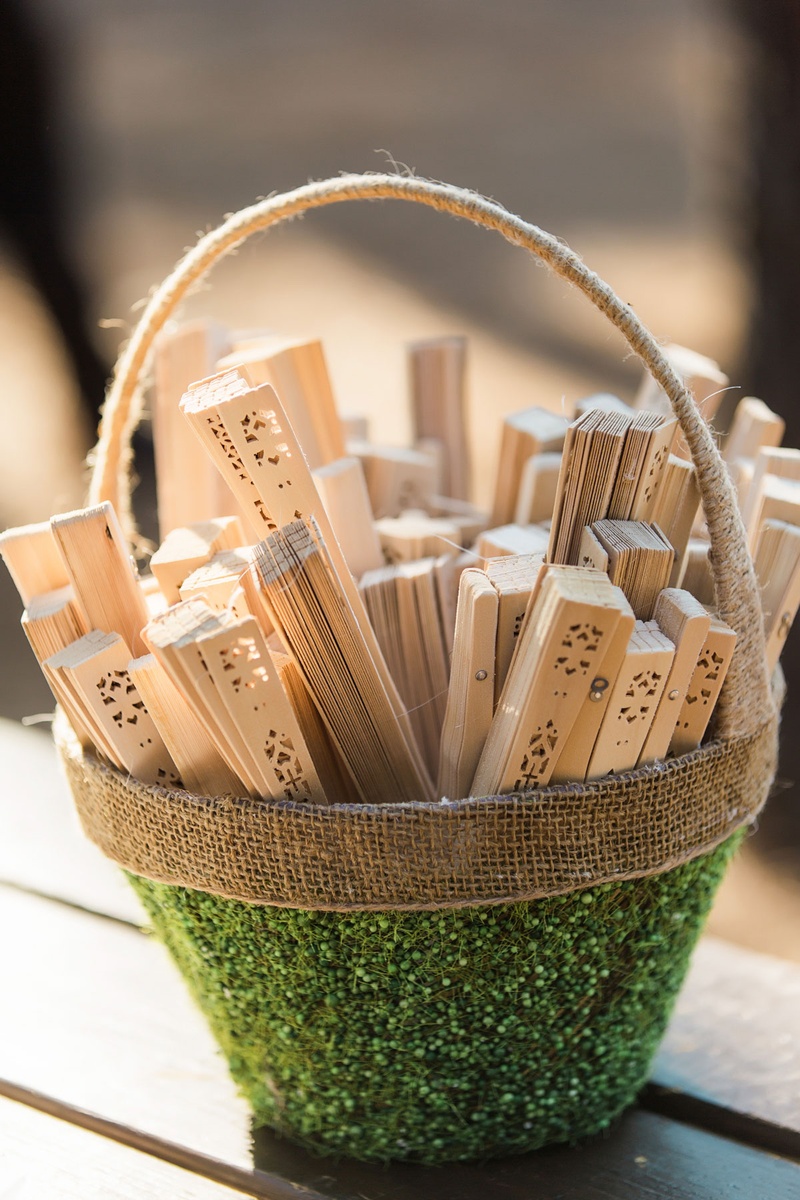 Wood Fans in Green Basket
Photography: Vue Photography
Read More:
http://www.insideweddings.com/weddings/summer-destination-wedding-with-rustic-elegant-decor-in-georgia/1032/ Wedding ceremony wood fans outdoor wedding favors Chinese fans in green and burlap basket