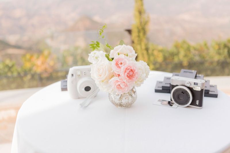 Cocktail Table with Instant Cameras
Photography: Love %26 You Studios
Read More:
http://www.insideweddings.com/weddings/destination-wedding-with-unique-personalized-elements-in-malibu/1079/ Wedding reception white linen cocktail table with pink and white flower bud vase instax cameras