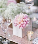 Blushing Dahlia in Modern Vase
Photography: Ryan Phillips Photography
Read More:
http://www.insideweddings.com/weddings/outdoor-ranch-wedding-with-neutral-sparkling-decor-in-california/675/ Wedding wood reception table with light pink sequined runner, light pink dahlia in white vase
