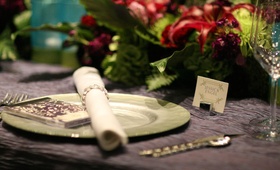 Green %26 Purple Table Setting
Photography: Jenn Barnett Photos
Read More:
http://www.insideweddings.com/weddings/peacock-themed-june-wedding-in-minnesota/283/ Purple silk linen with light green charger plate