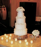 Four Layer White Wedding Cake
Photography: Lawrence Crandall Photography
Read More:
http://www.insideweddings.com/weddings/timeless-michigan-wedding-in-neutral-palette/201/ Small ivory wedding confection with candles