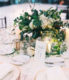 Gold Chargers %26 Centerpiece Accents
Photography: Mallory Dawn Photography
Read More:
http://www.insideweddings.com/weddings/outdoor-jewish-ceremony-luxe-reception-at-vibiana-in-downtown-la/1259/ wedding reception centerpiece greenery white flowers calligraphy table number gold terrarium candles