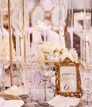 Gold Frame Table Number %26 Flatware
Photography: Amy Anaiz Photography
Read More:
http://www.insideweddings.com/weddings/luxurious-royal-inspired-ballroom-real-wedding-at-a-castle-venue/1365/ wedding reception table gold flatware and charger plate white flowers gold rim glassware tall riser