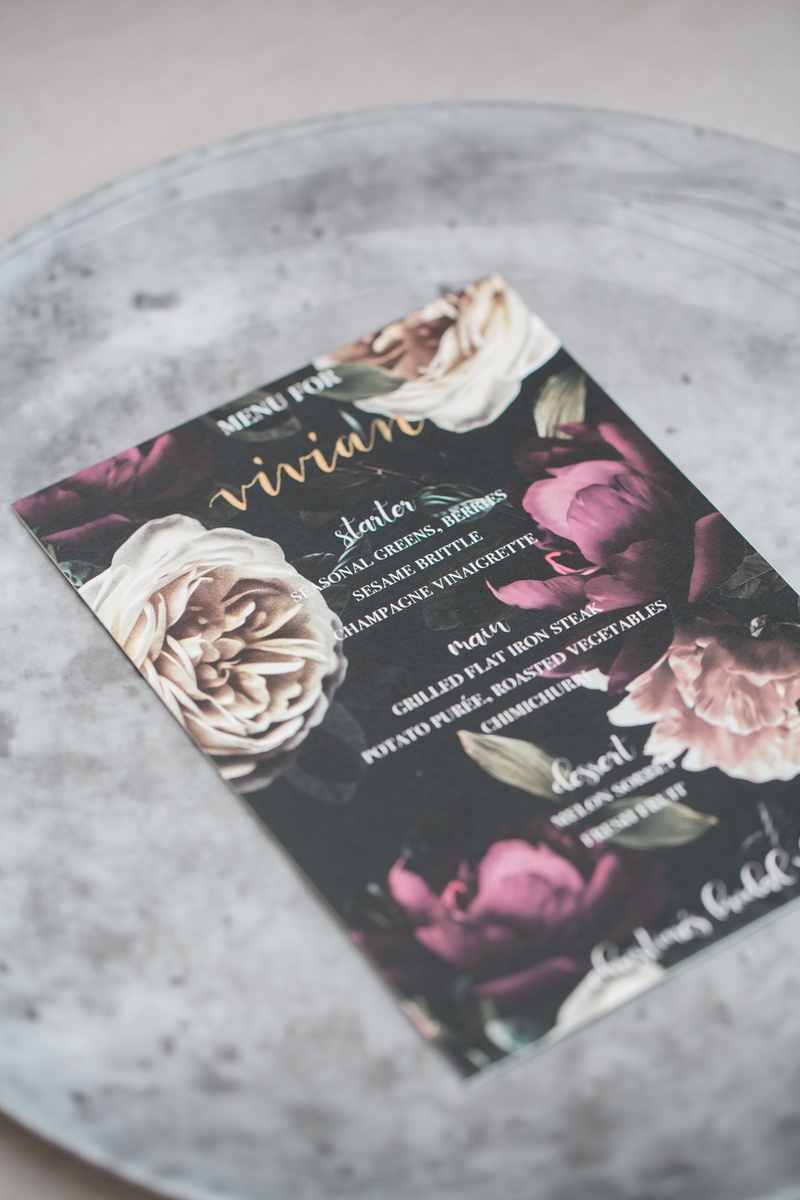 Dark-Hued Menu with Large Flowers
Photography: Jessica Claire Photography
Read More:
http://www.insideweddings.com/weddings/unique-chic-bridal-shower-with-dark-and-moody-color-scheme/1335/ bridal shower menu with black background & cream & magenta flowers, grey concrete style charger