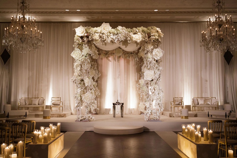 Oversized Floral Chuppah with Furniture
Photography: Bob %26 Dawn Davis Photography
Read More:
http://www.insideweddings.com/weddings/modern-glamorous-jewish-wedding-with-unique-decor-in-chicago/1154/ wedding furniture gold on both sides of chuppah with white flower accents candlelight lit up boxes