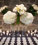 White Flowers at Escort Card Table
Photography: Duke Photography
Read More:
http://www.insideweddings.com/weddings/alfresco-ceremony-modern-reception-in-southern-california/1123/ Wedding reception tall glass vases filled with hydrangea, calla lily rose flowers hexagon marble