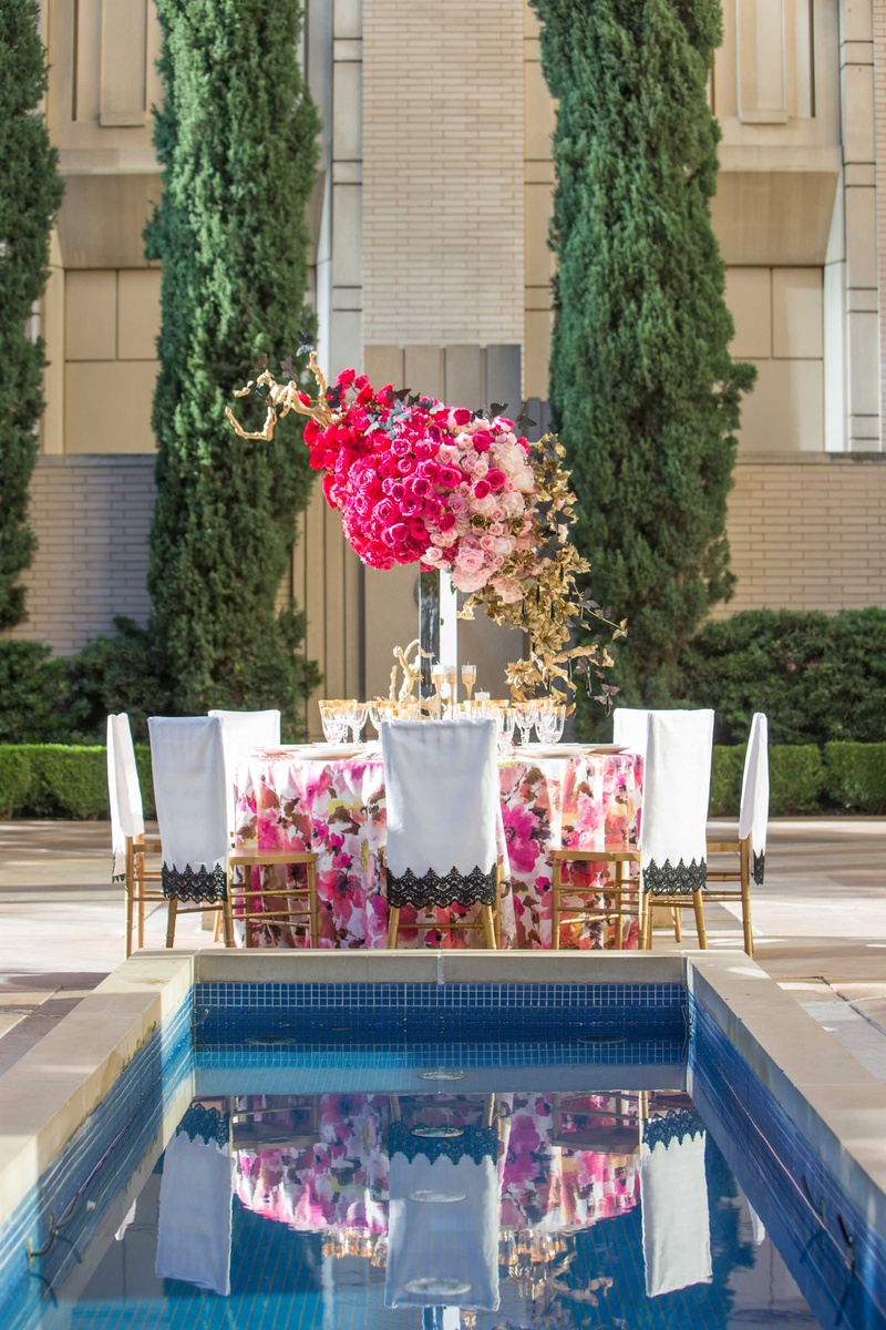 Pink, White, and Gold Reception Table Reflected in Pool
Photography: Thisbe Grace Photography
Read More:
http://www.insideweddings.com/weddings/dramatic-wedding-shoot-inspired-by-alexander-mcqueen-chanel/749/ floral table linen white chair sleeve pink rose centerpiece arrangement reflected in pool
