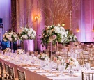 Long Dinner Table with Alternating Floral Arrangments