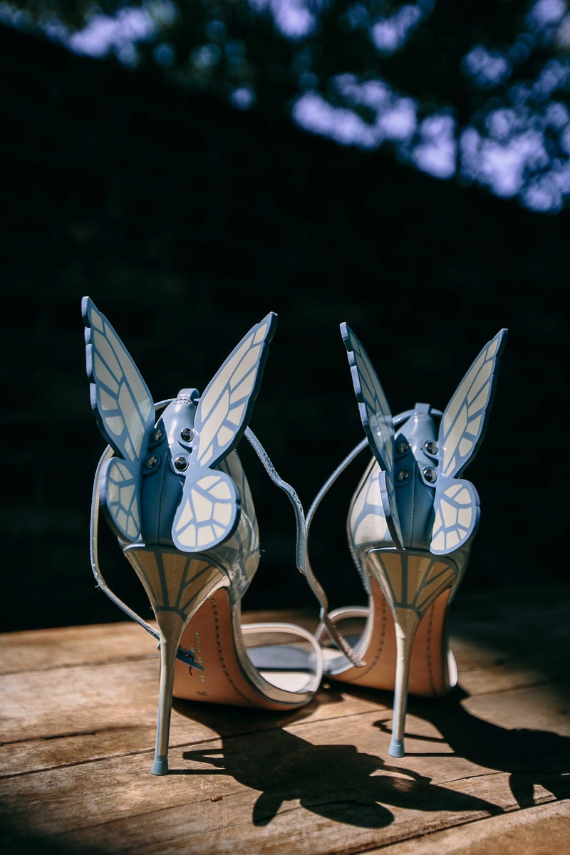 Blue High Heels with Butterfly Wings
Photography: Callaway Gable
Read More:
http://www.insideweddings.com/weddings/alfresco-summer-wedding-with-lush-foliage-accents-in-california/805/ a brides light blue high heels that feature butterfly wings with patterns off of the back