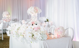 Florals Along Front of Sweetheart Table
Photography: Jodee Debes Photography
Read More:
http://www.insideweddings.com/weddings/elegant-alfresco-ceremony-reception-with-parisian-elements/1176/ sweetheart table with white linen, front of table lined with lush display of orchids and ivory roses