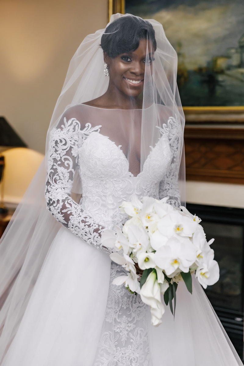 Bride in A-Line Gown with Veil
Photography: Amy Anaiz Photography
Read More:
http://www.insideweddings.com/weddings/modern-elegant-wedding-with-warm-inviting-white-gold-decor/1370/ bride in illusion neckline long sleeve a line wedding dress overskirt white orchid bouquet veil