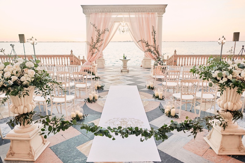 Romantic Ceremony on Patio
Photography: Binaryflips Photography
Read More:
http://www.insideweddings.com/weddings/bayfront-ceremony-garden-courtyard-reception-in-sarasota-florida/1344/ ca' d'van wedding ceremony on porch overlooking ocean, chiavari chairs in half circle, blush chuppah