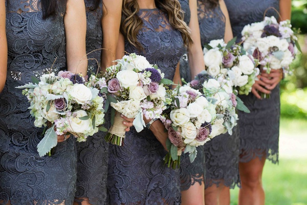 Bridesmaids In Short Lace Dresses With Garden Flowers Bridesmaids In Short Lace Dresses With Garden Flowers