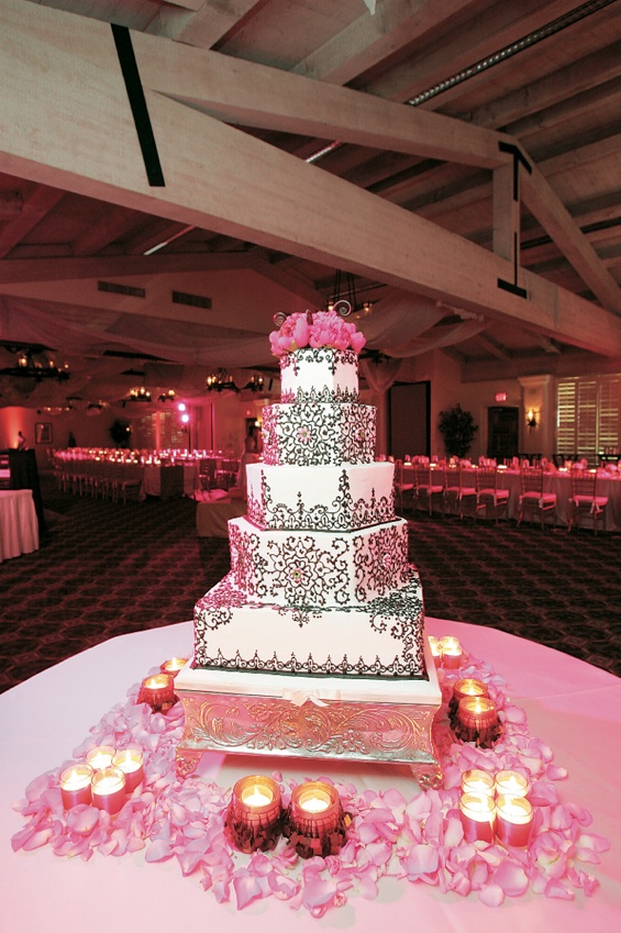 Scroll Wedding Cake
Photography: Asgeir Bollason for David Michael Photography
Read More:
http://www.insideweddings.com/weddings/pink-green-memorial-day-weekend-wedding-in-palm-desert/128/ White cake with chocolate scroll work and pink flower topper