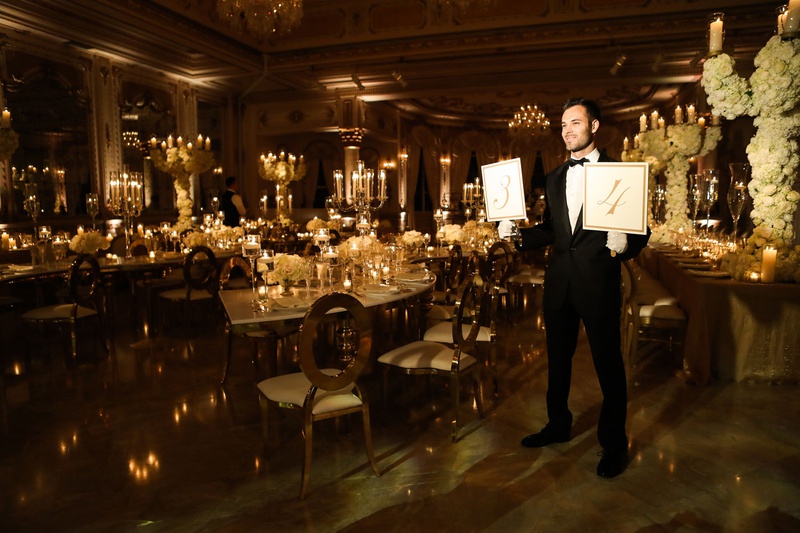 Usher for Wedding Reception
Photography: Alain Martinez Photography
Read More:
http://www.insideweddings.com/weddings/opulent-luxury-wedding-with-white-gold-color-scheme-in-palm-beach/1375/ man in tuxedo holding table number signs leading guests to their table wedding ideas