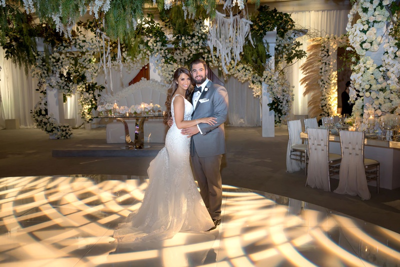 Bride %26 Groom on Illuminated Dance Floor
Photography: Curtis Dahl Photography
Read More:
http://www.insideweddings.com/weddings/spring-outdoor-ceremony-ballroom-reception-with-cultural-elements/1313/ bride in form fitting wedding dress groom in grey tuxedo dance floor with woven light projection