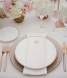 Place Setting with Rose Gold Flatware
Photography: Maitha Lunde
Read More:
http://www.insideweddings.com/weddings/beautiful-alfresco-destination-wedding-in-the-south-of-france/1039/ Wedding reception with charger plate napkin china and menu card with wax seal and rose gold fork