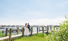 Bride and Groom on the Dock
Photography: Nicole Barr Photography
Read More:
http://www.insideweddings.com/weddings/ceremony-overlooking-the-bay-tented-reception-at-beach-house/1295/ bride in striped hayley paige wedding dress with groom in navy suit on private dock