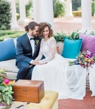 Couple at Colorful Lounge Area
Photography: Lucas Rossi
Read More:
http://www.insideweddings.com/weddings/vibrant-styled-shoot-with-colorful-bohemian-inspired-details/793/ bride and groom in wedding lounge area with blue purple pillows flower arrangement