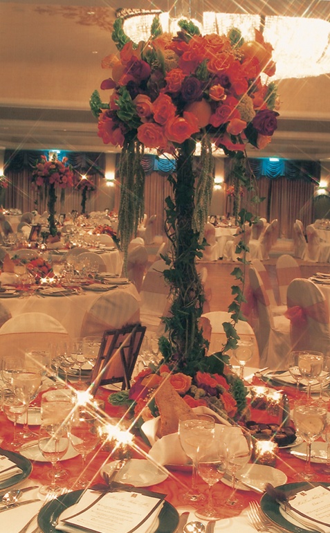 Orange and Green Wedding Reception
Photography: Simone %26 Martin Photography
Read More:
http://www.insideweddings.com/weddings/a-midsummer-nights-dream-wedding-in-beverly-hills-california/58/ table with orange tablecloth and centerpiece with green base and orange flowers