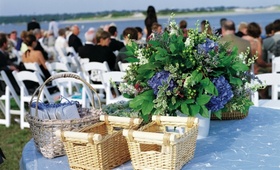 Basket Ceremony Table
Photography: MBV Photography
Read More:
http://www.insideweddings.com/weddings/seaside-wedding-with-colorful-details-in-massachusetts/202/ Blue linens on round table with wicker baskets at wedding