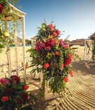 White Lanterns with Cascading Florals
Photography: Juan Carlos Tapia Photography
Read More:
http://www.insideweddings.com/weddings/rustic-destination-wedding-with-touching-details-on-beach-in-mexico/801/ white lanterns with cascading floral arrangements of red and orange flowers including roses on beach