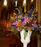 Vibrant Ceremony Arrangement at Church
Photography: KingenSmith
Read More:
http://www.insideweddings.com/weddings/colorful-ballroom-wedding-in-chicago-with-enchanted-forest-theme/820/ ceremony flower arrangement with stargazer lilies, stocks, bright colors, white vase