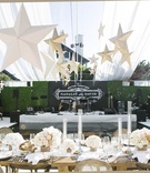 Personalized Stage Backdrop
Photography: Samuel Lippke Studios
Read More:
http://www.insideweddings.com/weddings/elegant-summer-beach-wedding-in-southern-california/537/ Table and chairs in front of elevated entertainment stage