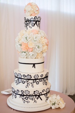 Photography: Carrie Rodman Photography
Read More:
http://www.insideweddings.com/inspiration/board/126/iwadmin2/floral-cakes/ White cake with sugar flower bouquet and black floral motif