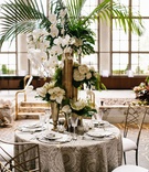 Tropical Tablescape with Tall Gold Décor
Photography: Melissa Kilner Photography
Read More:
http://www.insideweddings.com/weddings/glamorous-styled-wedding-inspired-by-moroccan-details-in-seattle/1253/ wedding reception styled moroccan wedding shoot pattern linen gold chair white flower palm greenery