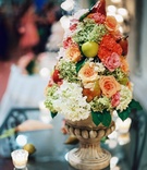 Fruit and Flower Centerpiece
Photography: M Bénédicte Verley Photography
Read More:
http://www.insideweddings.com/weddings/garden-wedding-at-lord-thompson-manor-in-connecticut/147/ Stone urn filled with rose and hydrangea flowers and apple and pear fruits