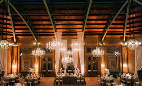 Rustic-Elegant Reception Space
Photography: Artistrie Co.
Read More:
http://www.insideweddings.com/weddings/rustic-elegant-celebration-with-personalized-elements-in-chicago/1026/ Wedding reception tall drapery crystal chandeliers with wood walls and rustic elements
