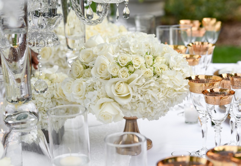 Small Arrangement of Roses and Hydrangeas
Photography: Carasco Photography
Read More:
http://www.insideweddings.com/weddings/styled-shoot-combines-old-world-charm-and-contemporary-fashion/849/ white roses and hydrangeas in small arrangement held by gold base