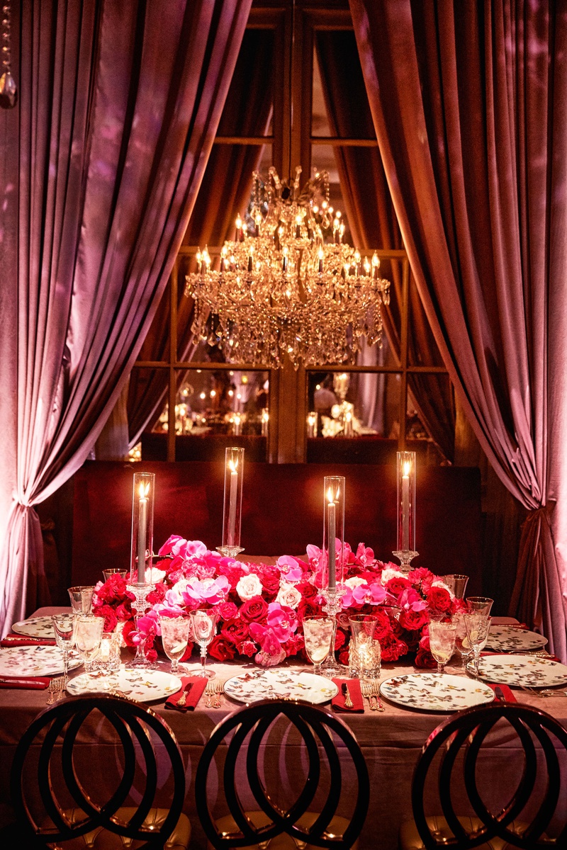 Taper Candles %26 Pink + Red Centerpiece
Photography: KingenSmith
Read More:
http://www.insideweddings.com/weddings/luxurious-wedding-featuring-sentimental-butterfly-decor-in-chicago/1348/ wedding reception table chandelier drapery pink red rose flowers butterfly china plates taper candle