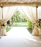 Ceremony Décor
Photography: Simone %26 Martin Photography
Read More:
http://www.insideweddings.com/weddings/soft-romantic-fall-winery-wedding-in-santa-barbara-california/344/ Tented wedding ceremony with large arrangement of white flowers at the entrance