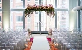 Lucite Chuppah with Foliage
Photography: Roey Yohai Photography
Read More:
http://www.insideweddings.com/weddings/colorful-fall-wedding-with-modern-details-in-new-york-city/971/ Indoor hotel wedding ceremony white aisle ombre flower petal aisle lucite chuppah with flowers top