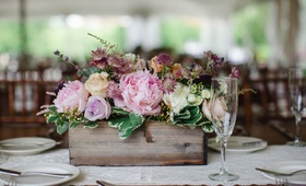 Pastel Floral Arrangement in Wooden Planter
Photography: Judith Rae
Read More:
http://www.insideweddings.com/weddings/whimsical-vintage-garden-wedding-with-rustic-details/826/ pink peonies, purple blossoms, lace table runner, greenery, wooden planter