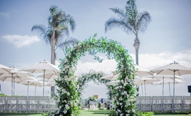 Alfresco Ocean-View Ceremony
Photography: Clane Gessel Photography
Read More:
http://www.insideweddings.com/weddings/ocean-view-ceremony-with-cultural-traditions-elegant-reception/1291/ wedding ceremony greenery arch white flowers grass lawn white chairs umbrellas shade palm trees
