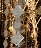 Unique Escort Card Display
Photography: Lyn Sims Photographer
Read More:
http://www.insideweddings.com/weddings/glamorous-fall-wedding-with-garden-touches-in-tucson-arizona/258/ Suspended crystal and metallic seating cards