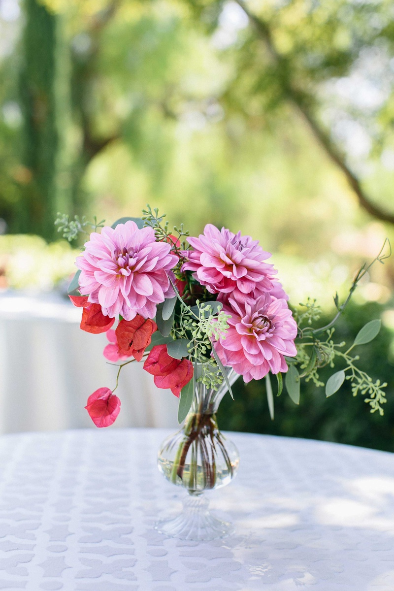 Small Pink %26 Green Floral Arrangement
Photography: Callaway Gable
Read More:
http://www.insideweddings.com/weddings/alfresco-summer-wedding-with-lush-foliage-accents-in-california/805/ a small floral arrangement of flowers in different shades of pink and foliage in small vase
