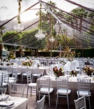 Chandeliers Suspended from Tent of Lights
Photography: Figge Photography
Read More:
http://www.insideweddings.com/weddings/fall-outdoor-wedding-at-a-luxury-resort-in-the-california-desert/1063/ Wedding reception outdoor silver chairs fall color centerpieces chandeliers tent made out of lights