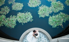 Couple Kiss Next to Pond
Photography: Kristina Lee Photography
Read More:
http://www.insideweddings.com/weddings/black-and-white-wedding-with-modern-mixed-metals-in-los-angeles/1009/ bird's eye view of bride and groom kissing next to pond with greenery skirball cultural center