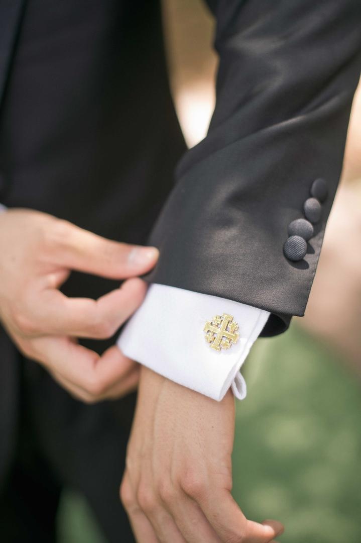 Gold Cross Cuff Link
Photography: Harwell Photography
Read More:
http://www.insideweddings.com/weddings/romantic-woodland-inspired-atlanta-wedding-with-natural-details/433/ Groom wearing Vatican gold Jerusalem cross cufflinks