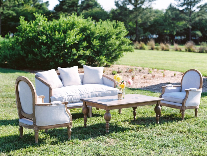 Upholstered Furniture %26 Wood Table on Lawn
Photography: Bonnie Sen Photography
Read More:
http://www.insideweddings.com/weddings/outdoor-ceremony-tented-reception-by-a-tranquil-river-in-maryland/1088/ Wedding reception upholstered rental furniture on lawn with wood coffee table yellow flowers lounge