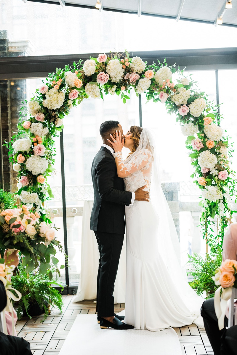 Passionate First Kiss
Photography: Kesha Lambert Photography
Read More:
http://www.insideweddings.com/weddings/personalized-ceremony-with-pink-florals-at-a-loft-in-new-york-city/1210/ bride grabs groom by the face for first married kiss under floral arch