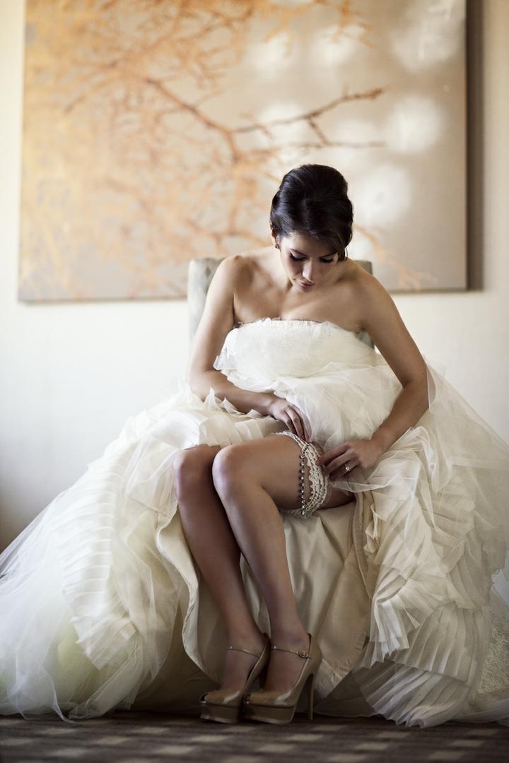 Bride Putting on Garter
Photography: Catherine Hall Studios
Read More:
http://www.insideweddings.com/weddings/metropolitan-san-francisco-wedding-at-luxury-hotel/411/ Woman in bridal gown wearing lace garter and heels
