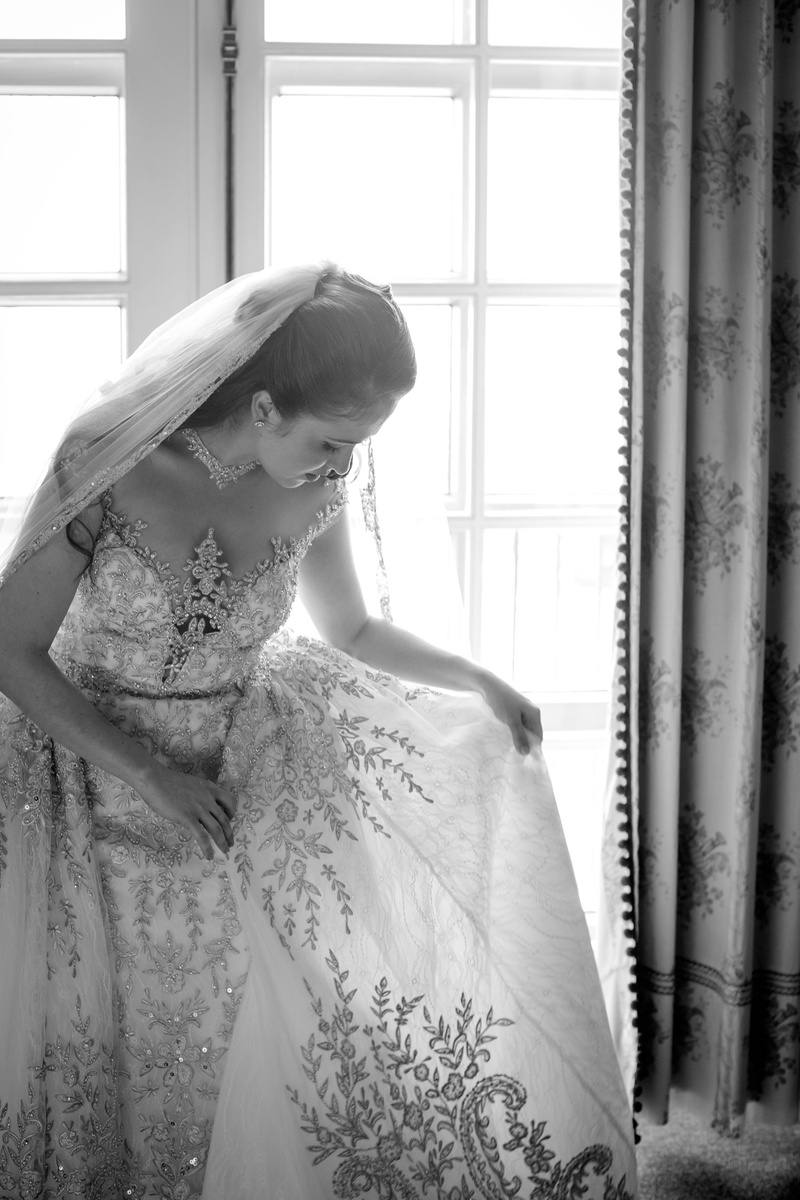 Bride Admiring Detailed Bridal Gown
Photography: Magnolia Studio
Read More:
http://www.insideweddings.com/weddings/charming-church-ceremony-romantic-ballroom-reception-in-quebec/1075/ Black and White Photo of bride looking at detail of wedding dress from Kleinfeld Bridal beading